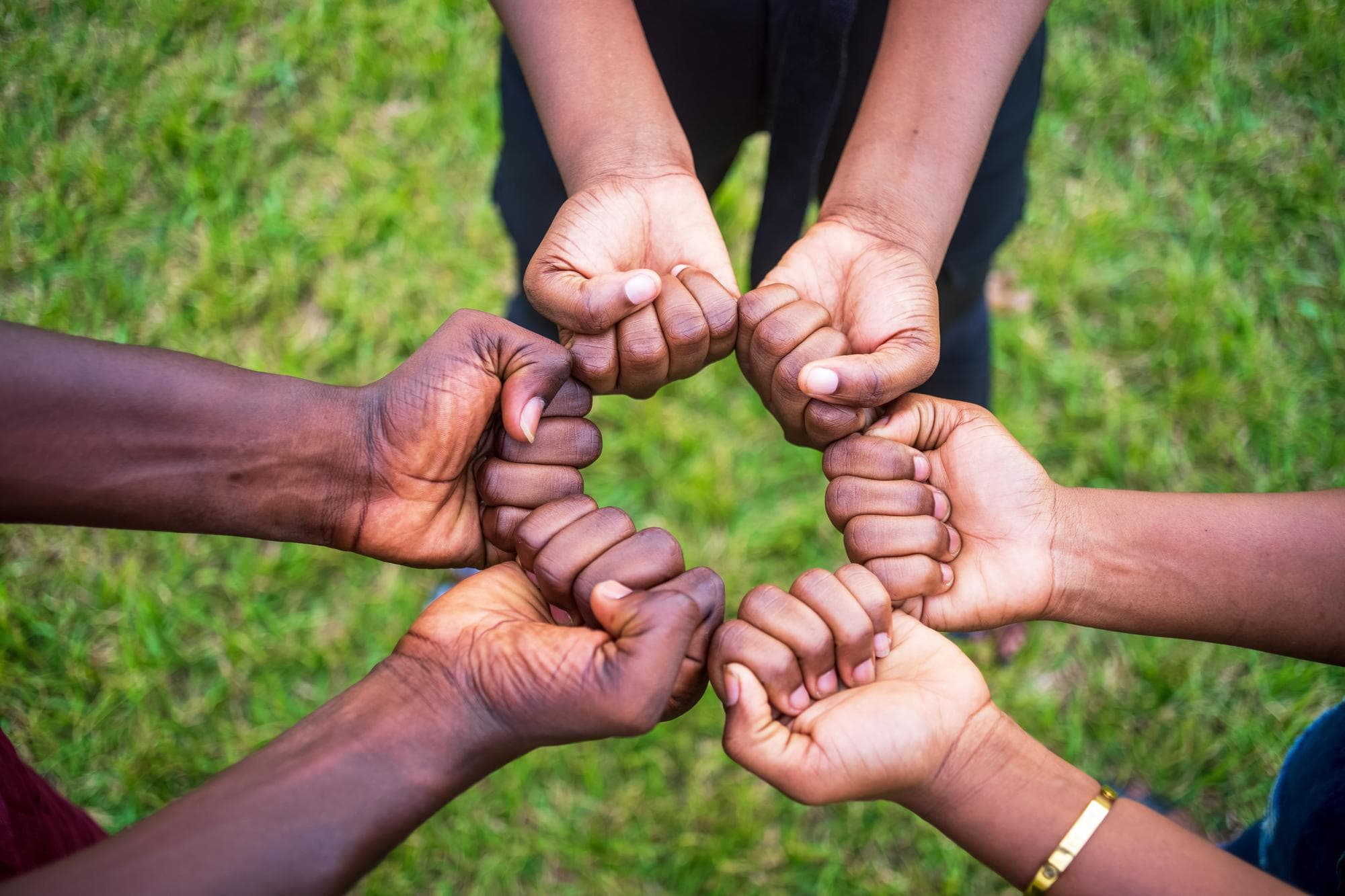 Members of GRACCU joining hands in a circle
